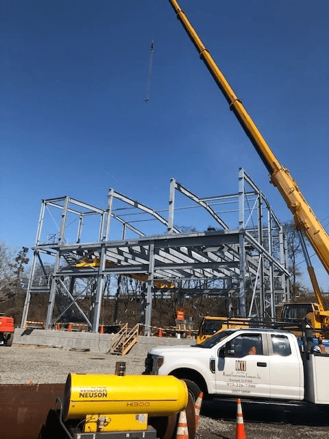 building frame with a crane and truck